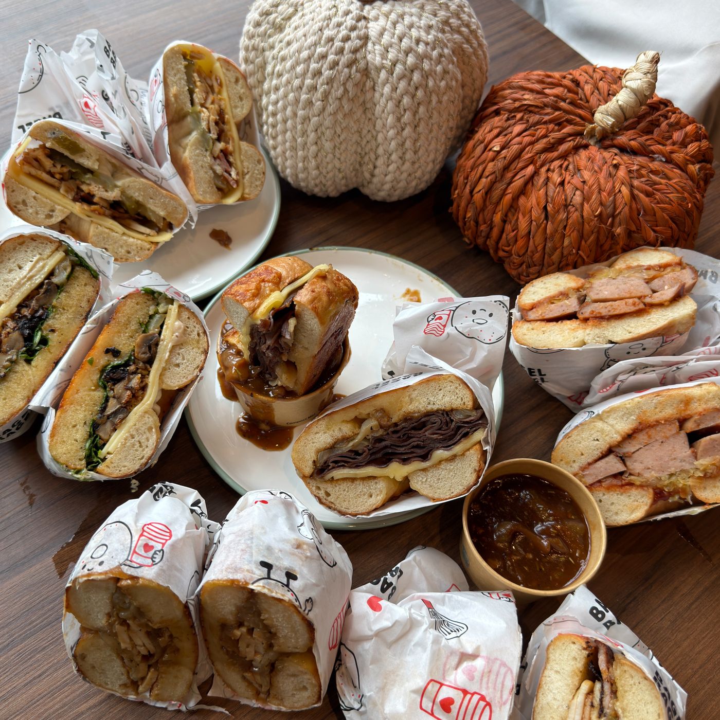 A table of wrapped bagels and bakes at Bagel Bagel
